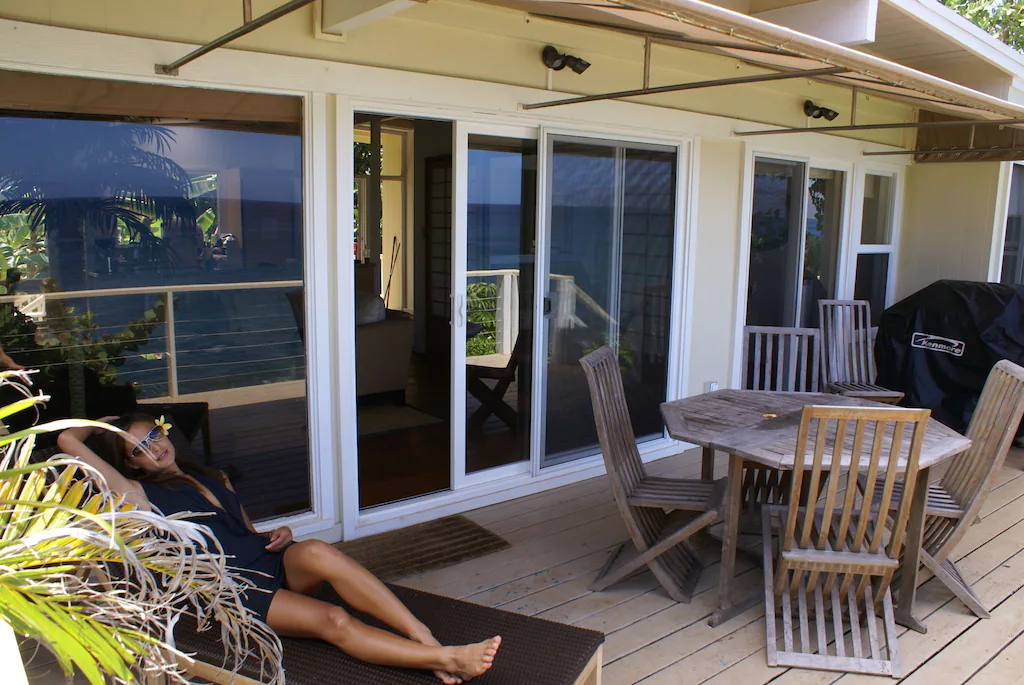 The oceanfront terrace has a chaise lounge, a BBQ, and a dining table for six people.