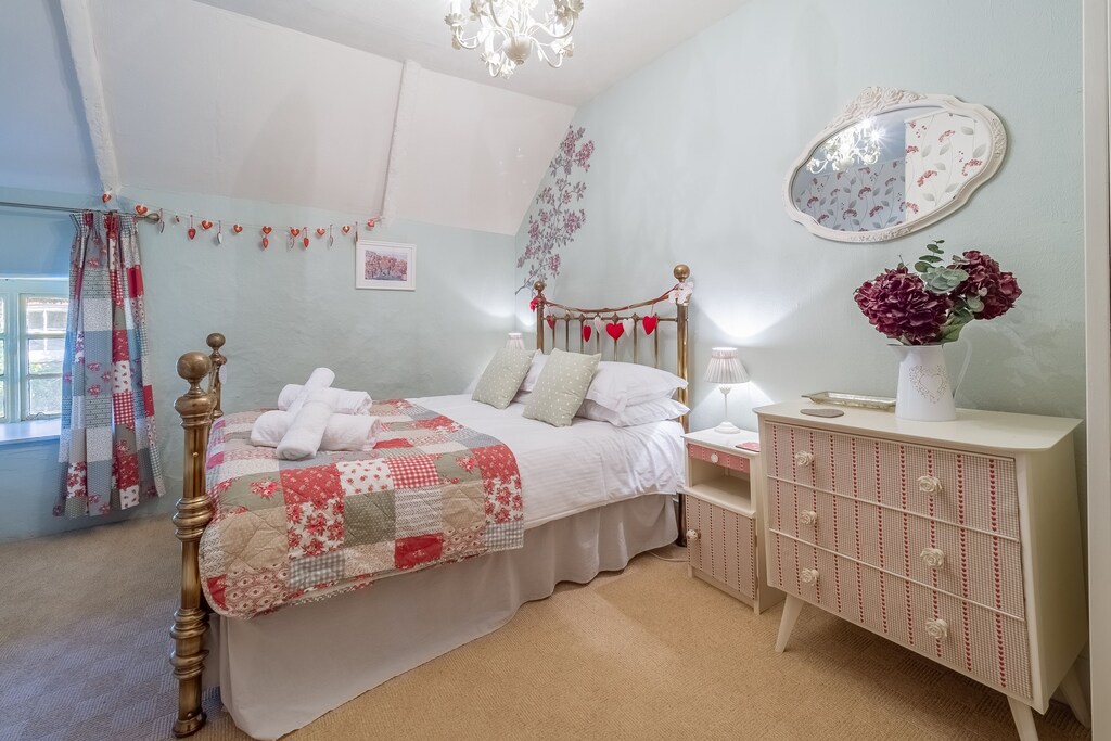 A charming room with a double bed.