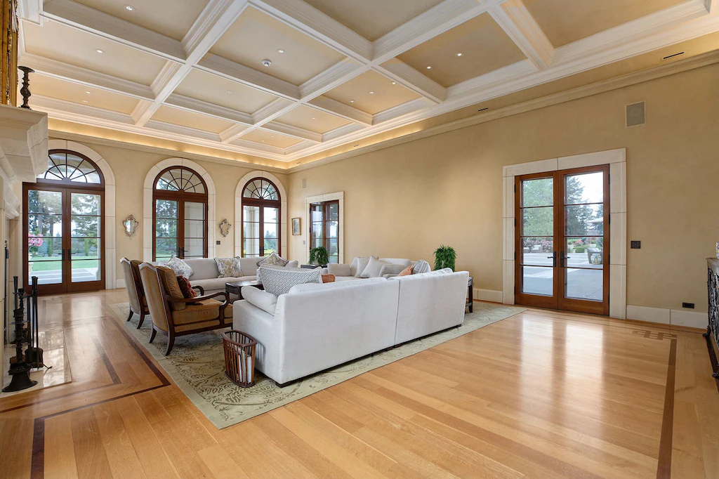One large formal indoor/outdoor living room with comfortable couches and a fireplace.