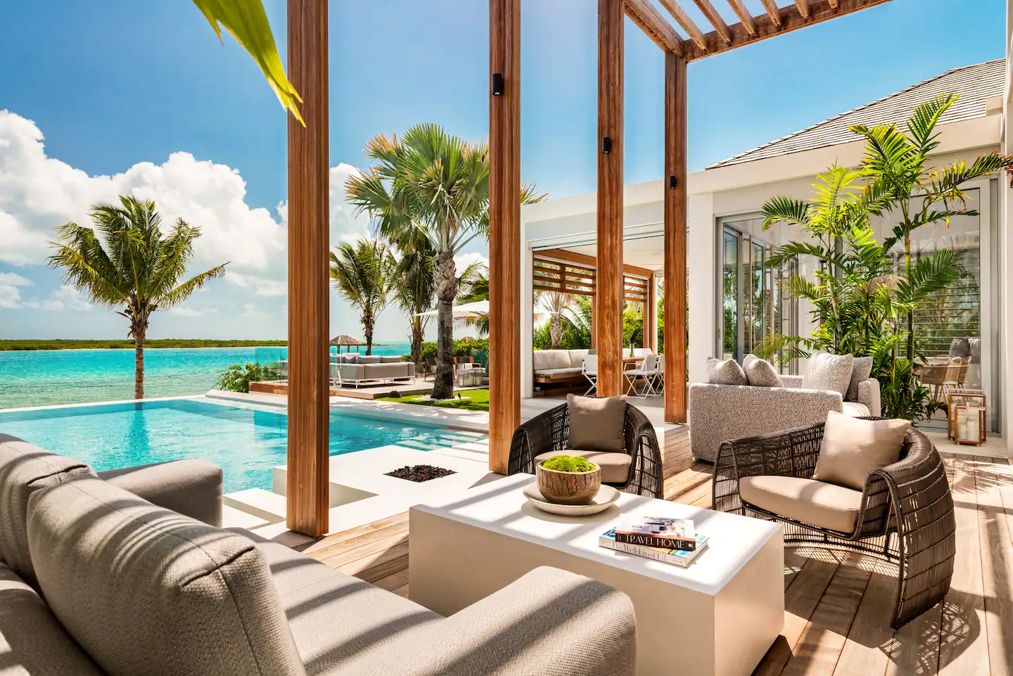 Adorned with elegant furniture, including plush outdoor sofas and armchairs