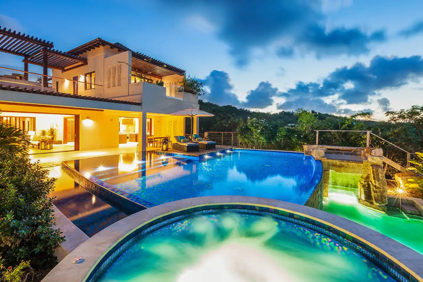 A stunning pool in the expansive grounds of this luxurious villa, featuring a spacious hot tub situated adjacent to the pool