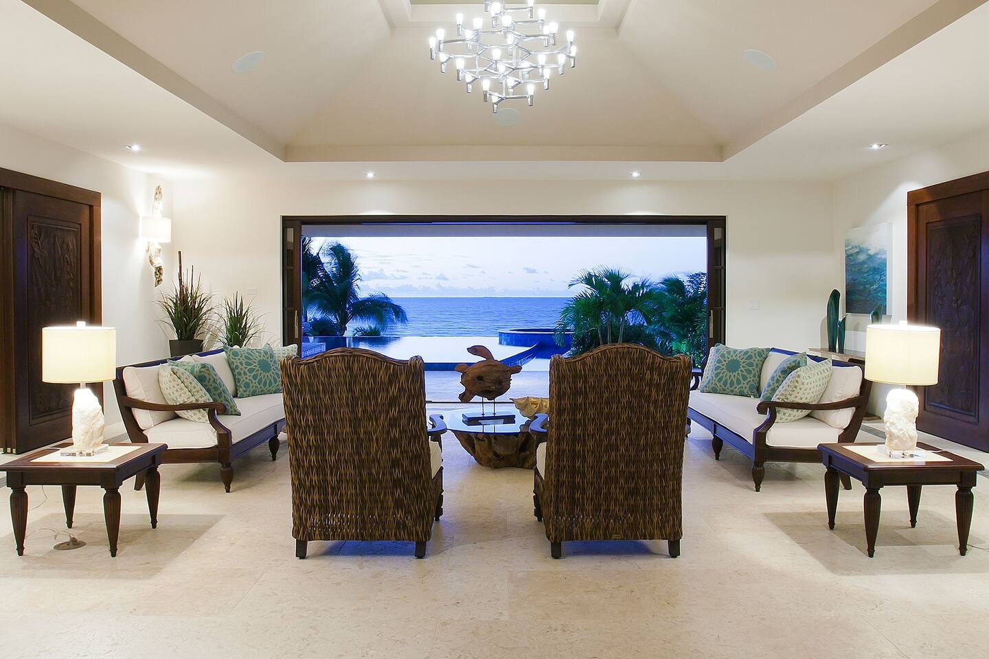 The great room is adorned with elegant furnishings, including a grand sofa, armchairs, and a stylish coffee table, creating an inviting and luxurious atmosphere.