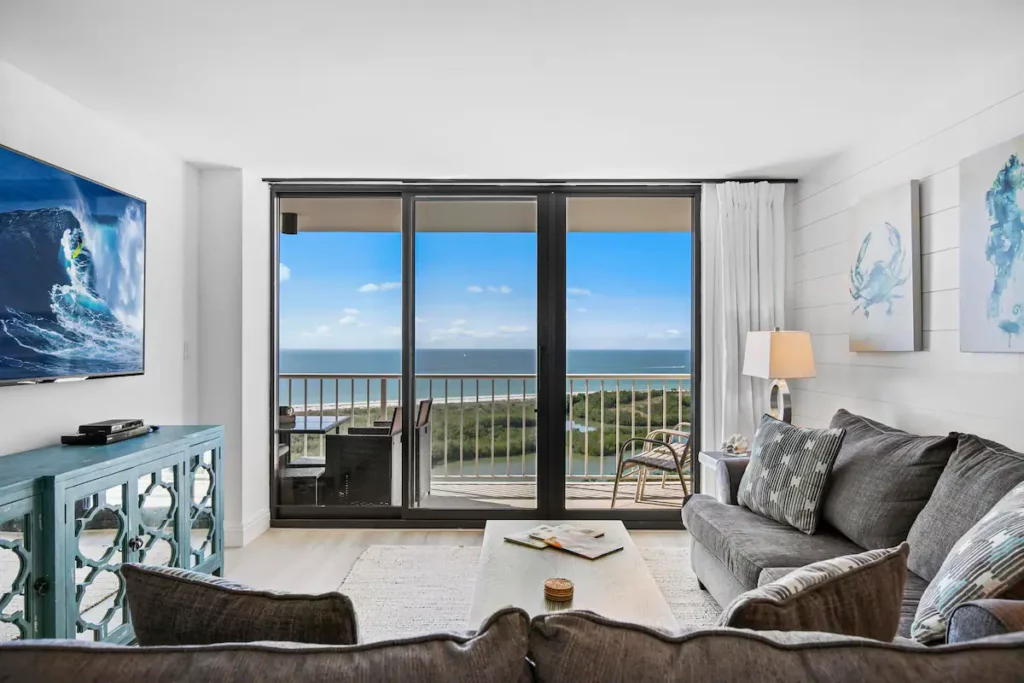 Beautiful coastal design, open concept living space overlooking the Gulf of Mexico and pool with a 70" smart TV and 10' sliding glass doors leading to the 25' balcony.
